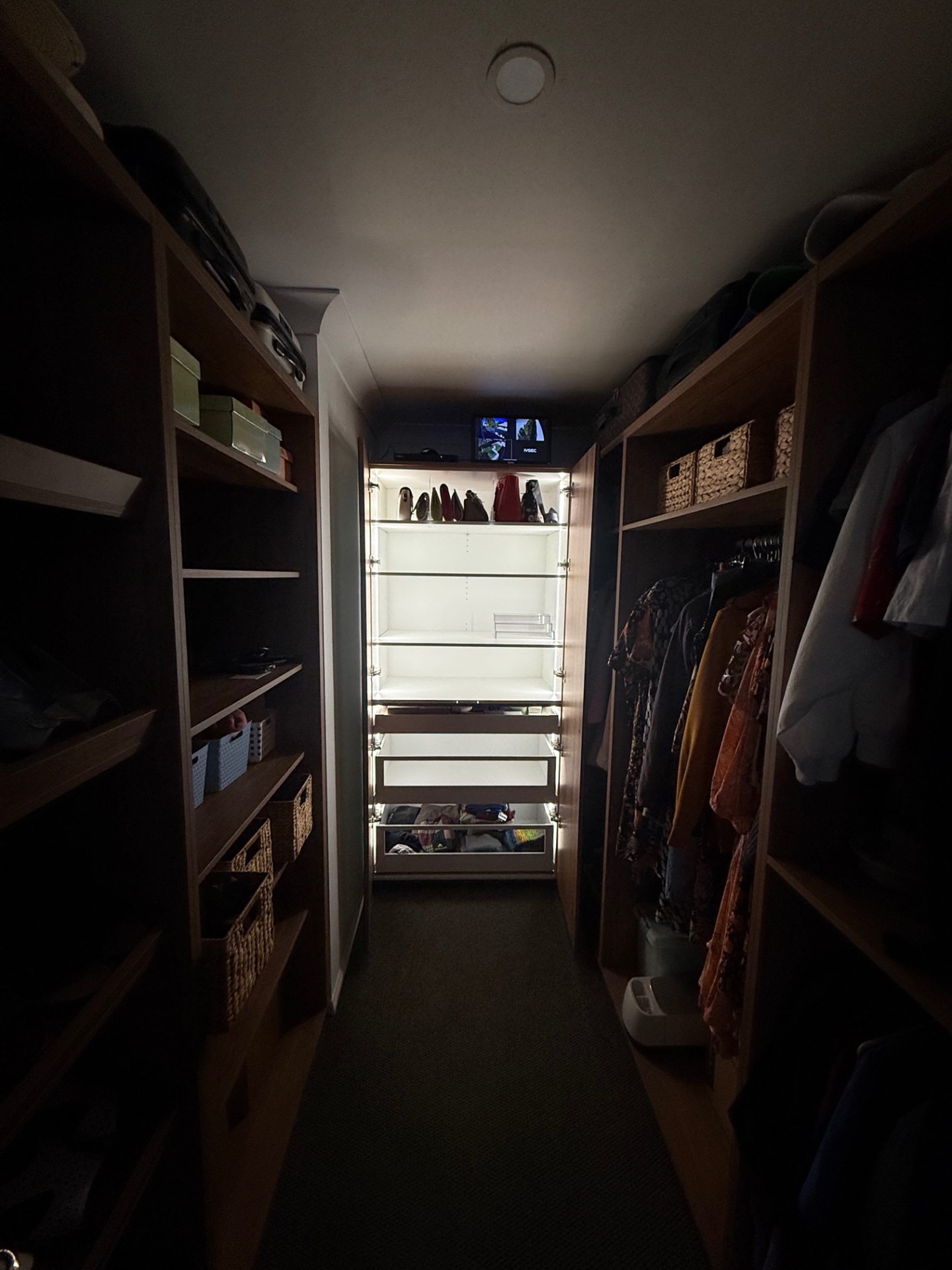 Walk-in wardrobe with warm LED strip lighting installed by NI Installations