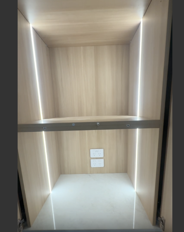 Backlit cabinet with recessed LED strips and power points by NI Installations