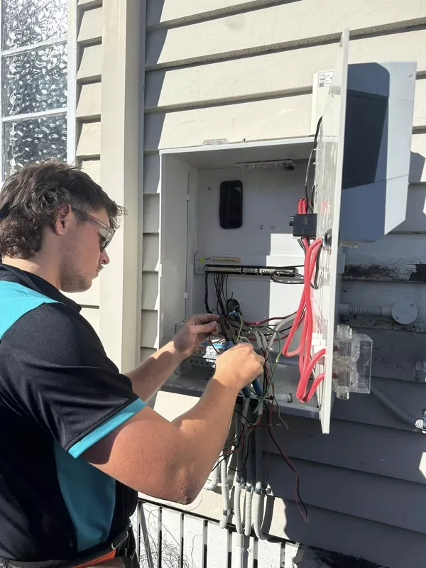 Licensed electrician wiring an external switchboard upgrade by NI Installations